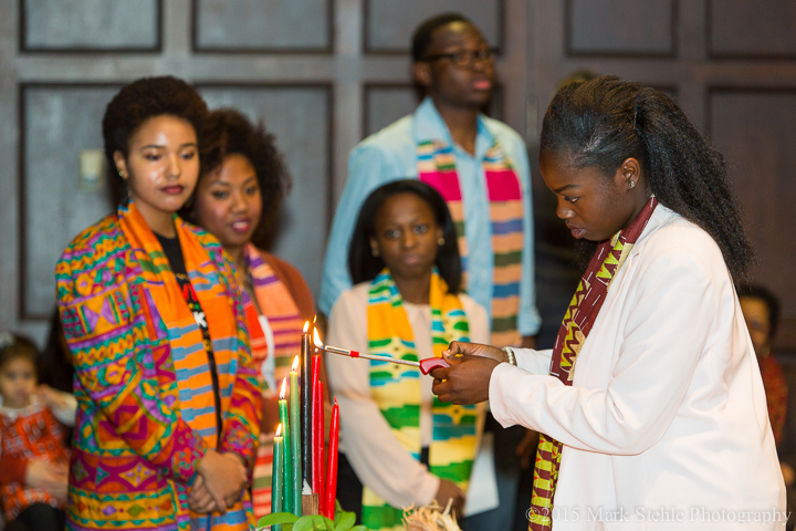 Tonna Obaze, a freshman, participates in a candle lighting ceremony during the Makuu Black Cultural Center Kwanzaa celebration in Houston Hall at the University of Pa. in Philadelphia Monday, Dec. 7, 2015. (©2015 Mark Stehle Photography)